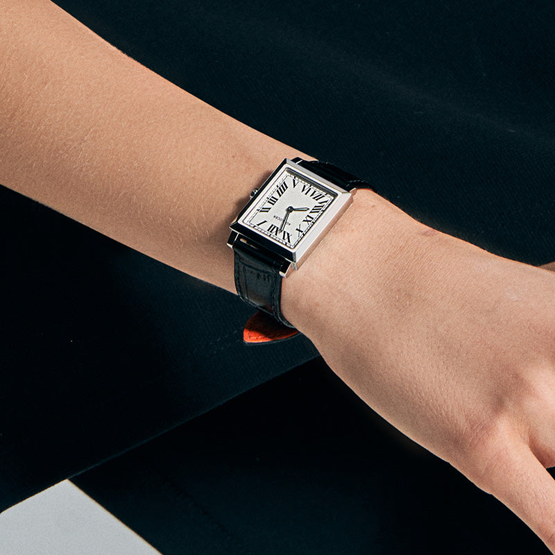Agelocer Codex Square Quartz Women's watch on the wrist, white Roman-numeral dial in a slim steel square case on a black leather strap