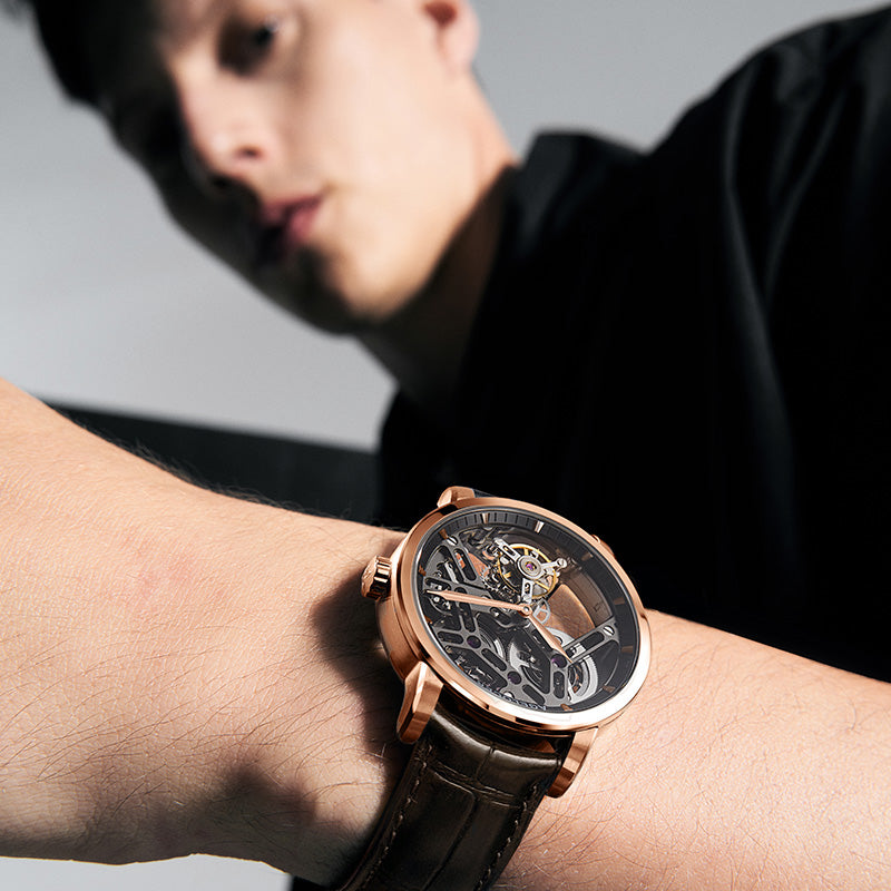 Rose gold Agelocer Manual Free-Sprung Tourbillon Skeleton on a wrist, the rotating tourbillon cage and balance wheel visible through the open-worked dial