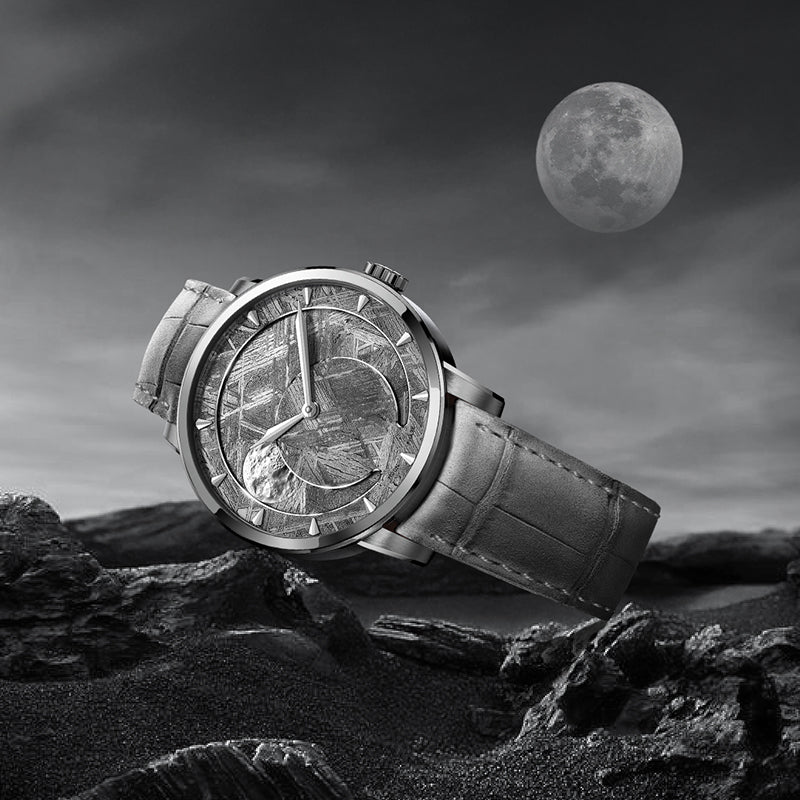 Agelocer Astronomer meteorite-dial moonphase watch against a lunar landscape, its sculpted moon disc showing a waning phase