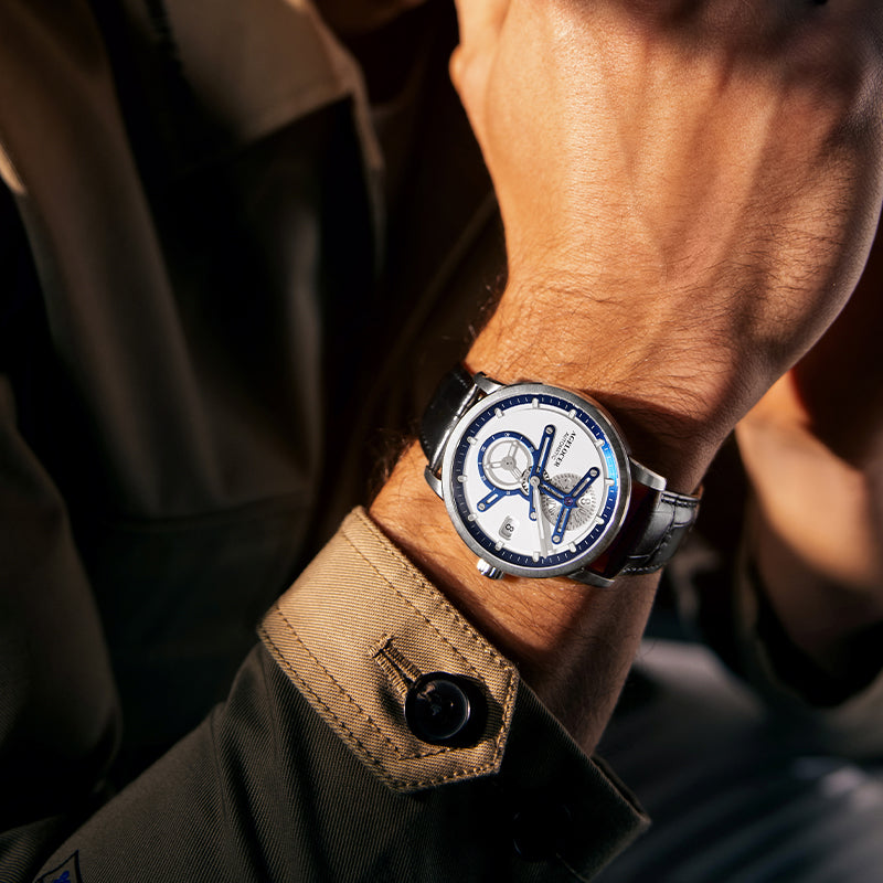 Agelocer Space Station Luminous on the wrist in low sunlight, synthetic sapphire crystal over a white separated dial
