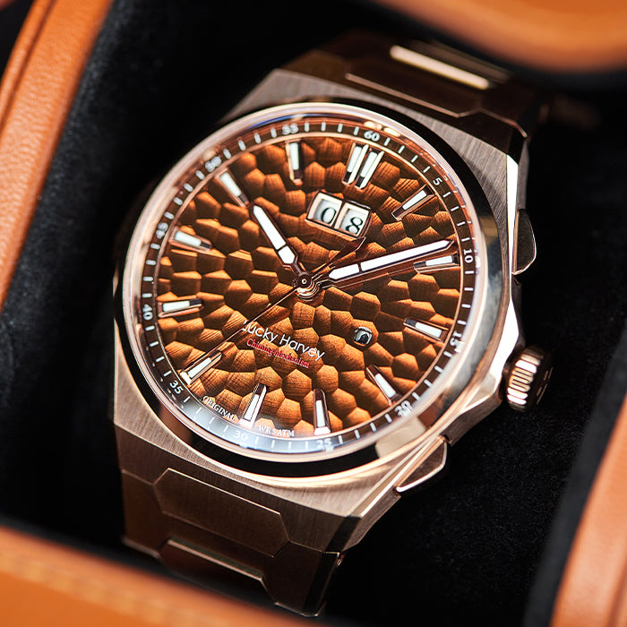 Lucky Harvey ZLS402-3 rose gold chiming watch in a tan travel case, chime pusher visible on the case flank