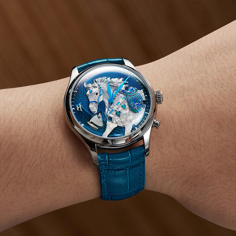 Lucky Harvey ZLS502-1 blue titanium horse watch with sculpted silver horse dial on a blue leather strap, worn on the wrist