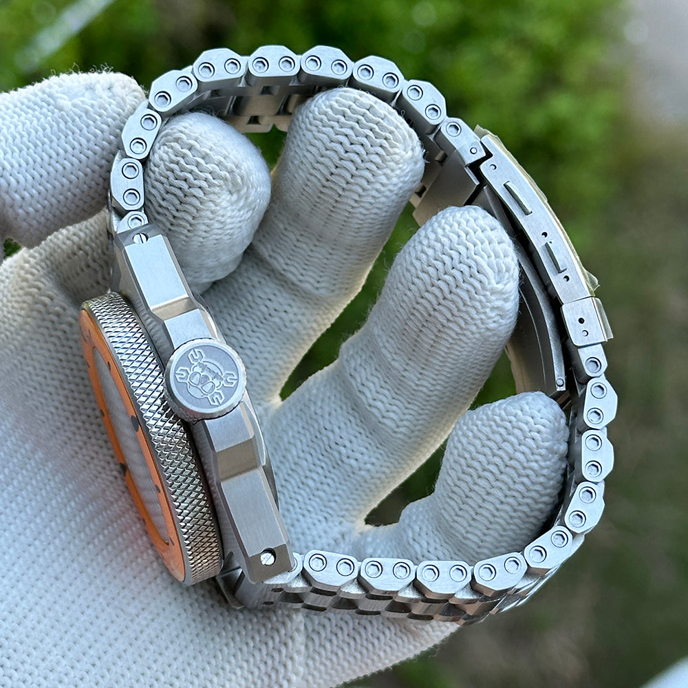 Brushed case side of the STEELDIVE SD2212 shown with a brown leather strap