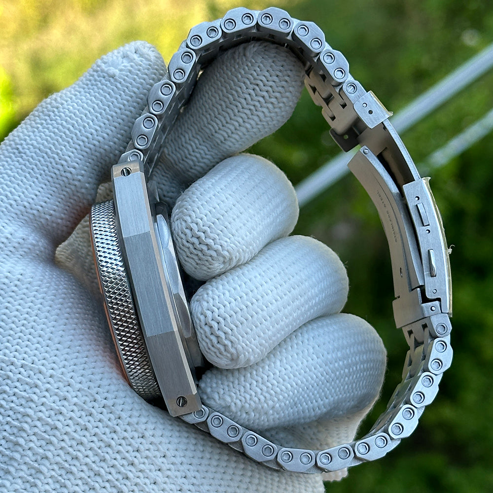 STEELDIVE SD2212 steel tank bracelet curved across a gloved hand showing the link screws