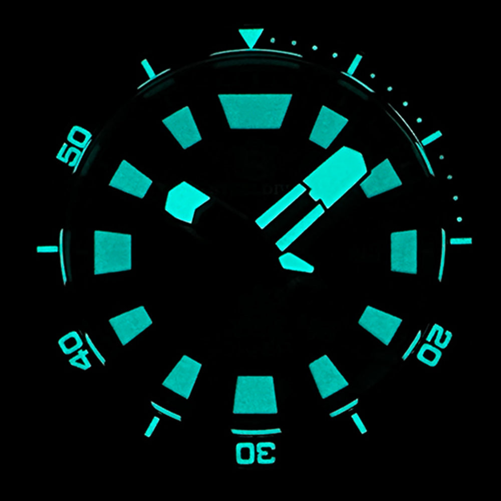 STEELDIVE SD1982F dial glowing blue in the dark, showing the sandwich-dial lume cutouts
