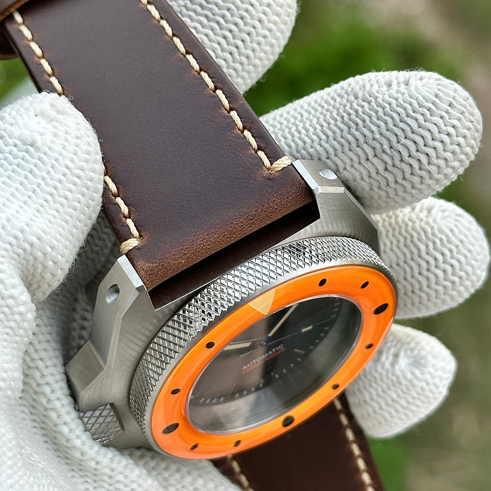 Angled case and orange bezel view of the STEELDIVE SD2212 on brown leather