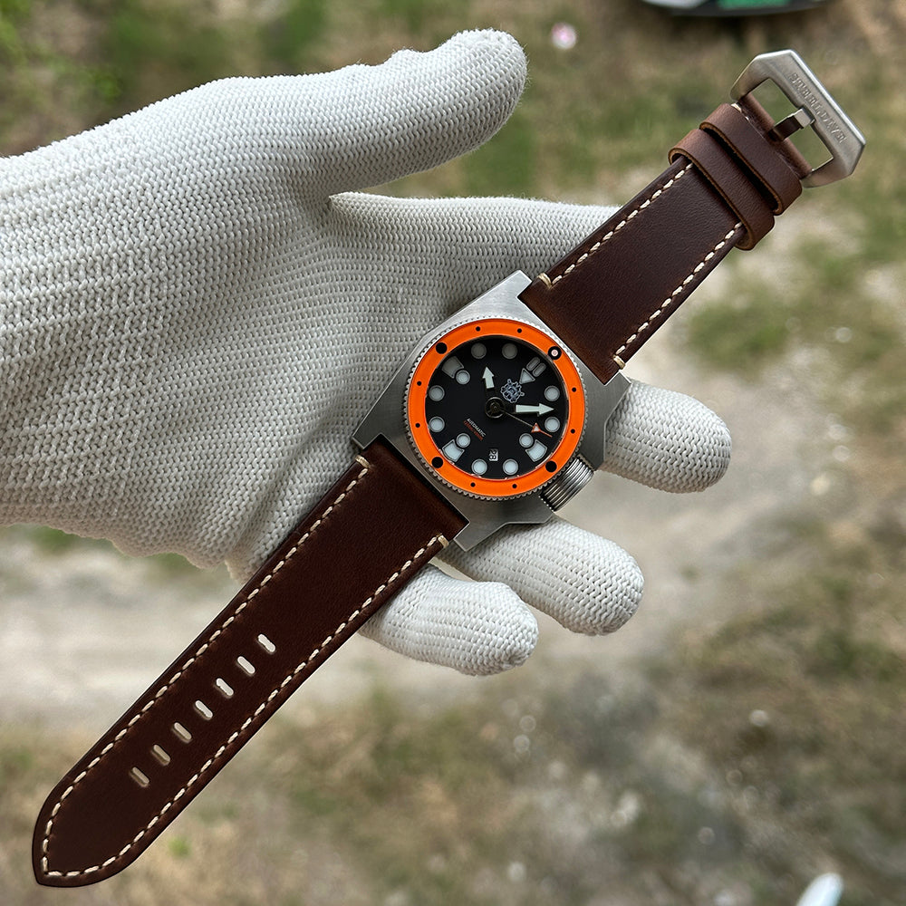 STEELDIVE SD2213 on a dark brown leather strap held across a gloved palm