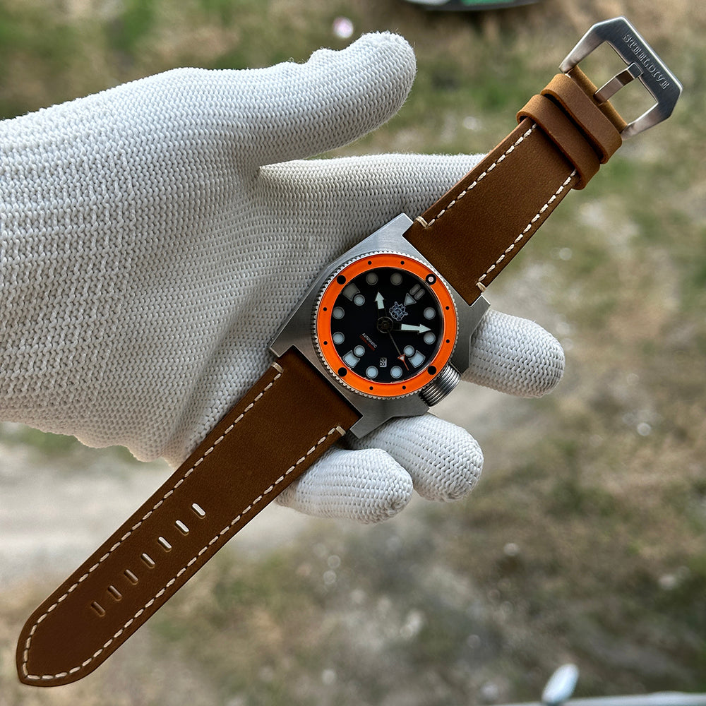 STEELDIVE SD2213 on a light brown leather strap laid full length on a gloved hand