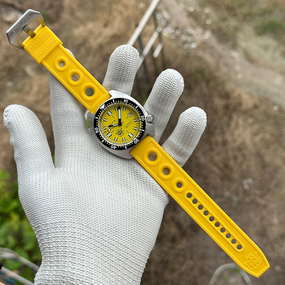 STEELDIVE SD1977T yellow dial on a yellow rubber strap held across a gloved palm