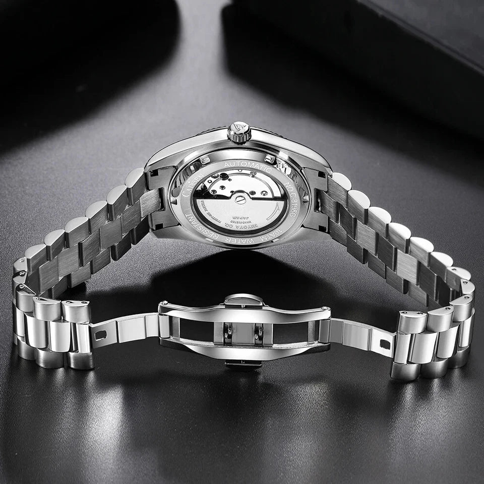 Silver watch with a metal band on a dark surface