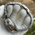 STEELDIVE SD1982F case side and steel bracelet curved across a gloved hand