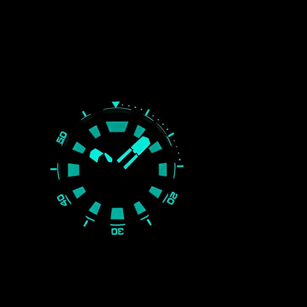STEELDIVE SD1982F dial glowing blue in the dark against a black background
