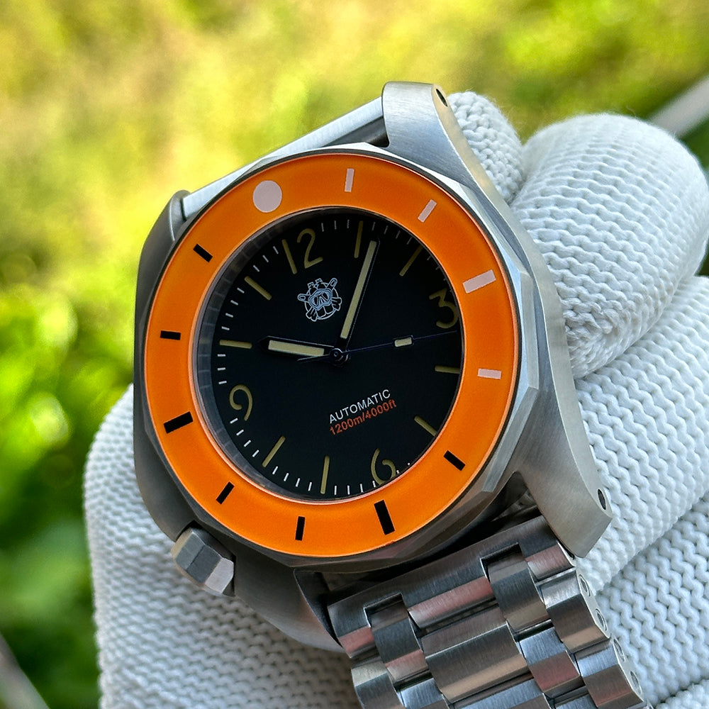 STEELDIVE SD2211 orange bezel and black dial on a steel tank bracelet, angled view