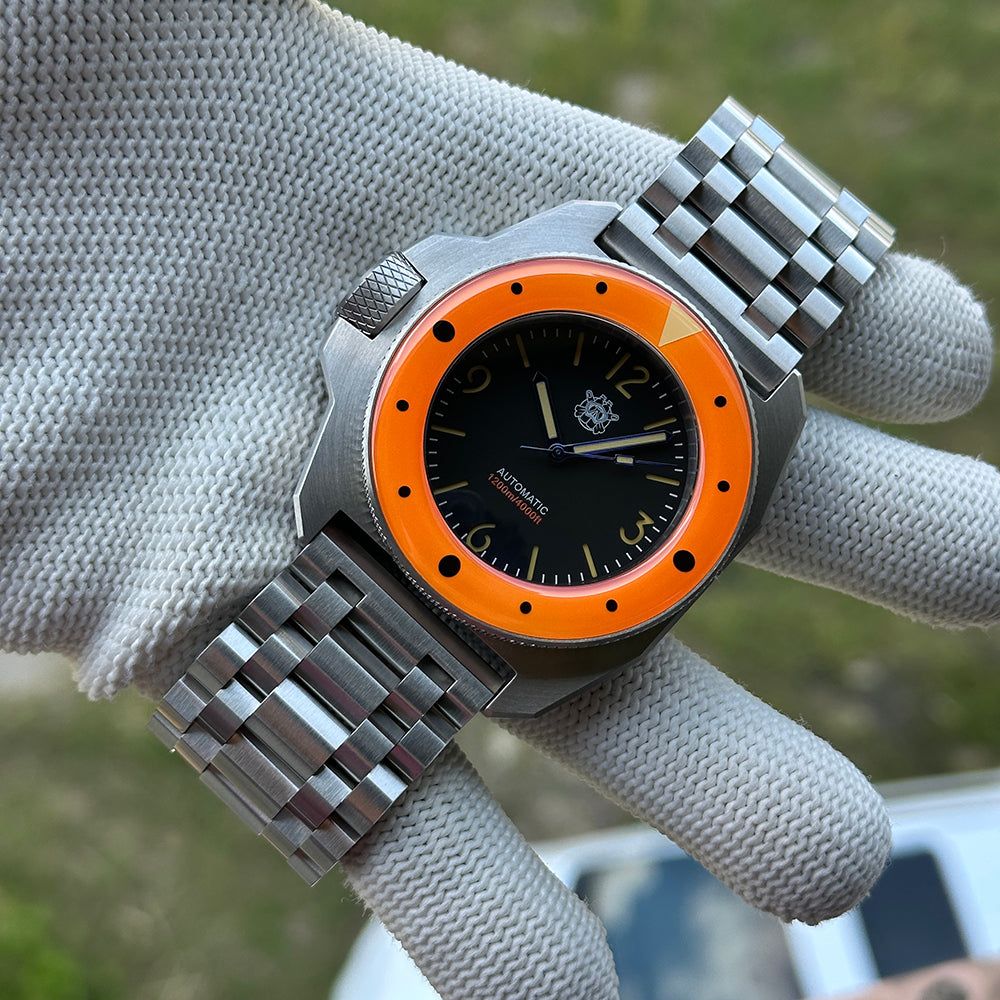 STEELDIVE SD2212 on its steel tank bracelet held in a gloved hand
