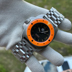 STEELDIVE SD2212 on its steel tank bracelet held in a gloved hand