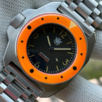 STEELDIVE SD2212 orange bezel dive watch with black dial on a steel tank bracelet