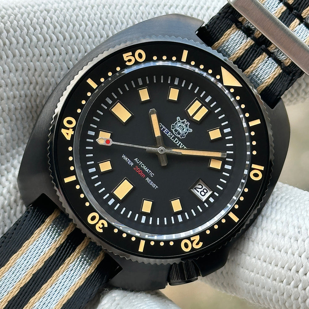 Close-up of the STEELDIVE SD1970X black dial and ceramic bezel on a nylon NATO strap