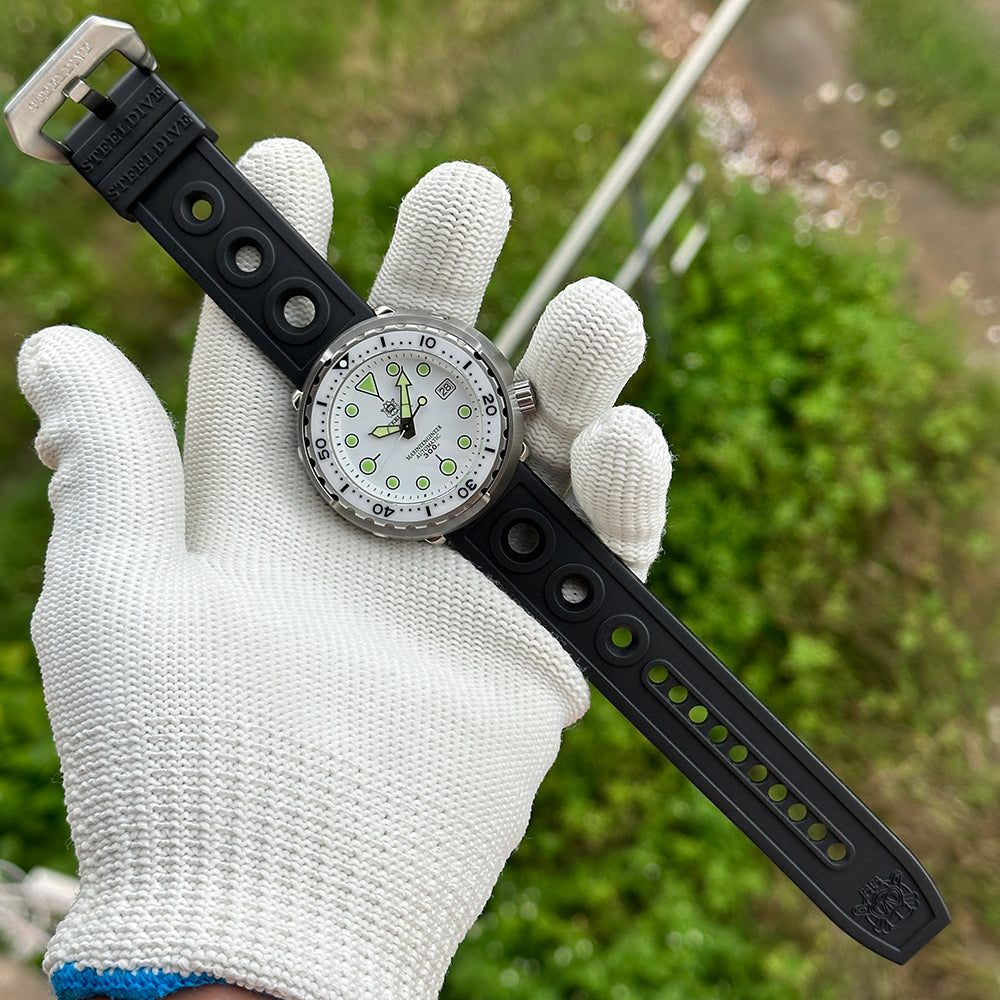 STEELDIVE SD1975B on a black rubber strap laid out full length on a gloved hand