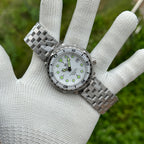 STEELDIVE SD1975B white dial and steel bracelet held in a gloved hand