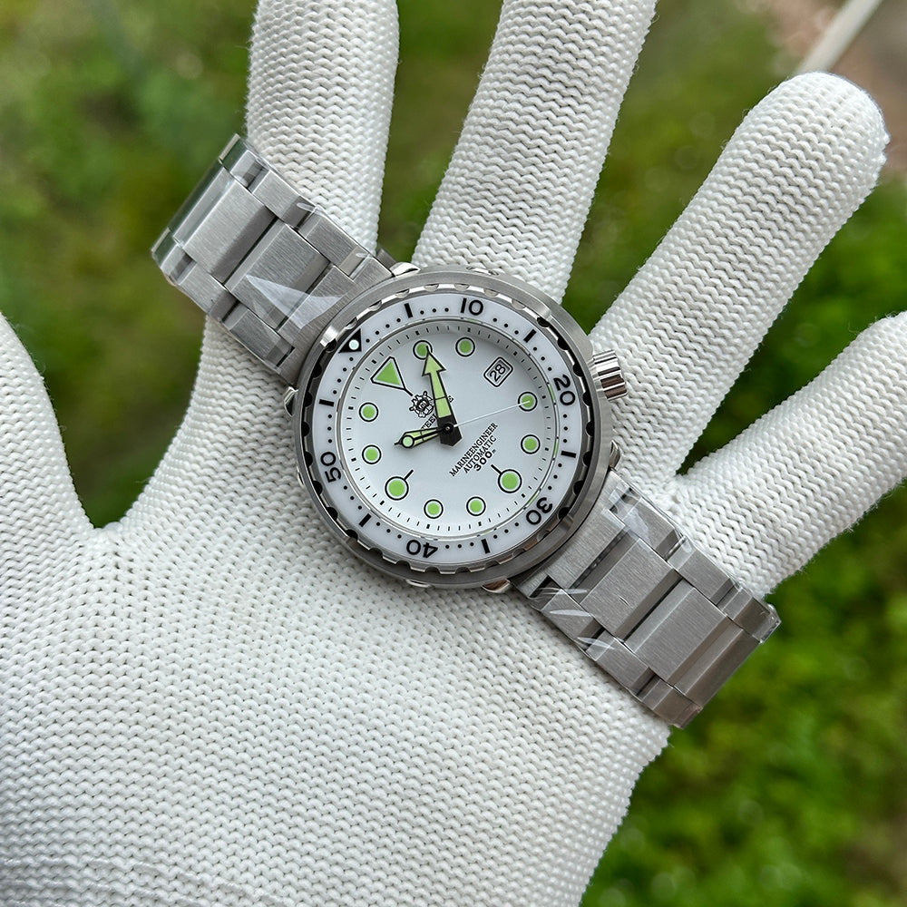STEELDIVE SD1975B on a steel bracelet held flat across a gloved palm