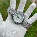 STEELDIVE SD1975B on a steel bracelet held flat across a gloved palm
