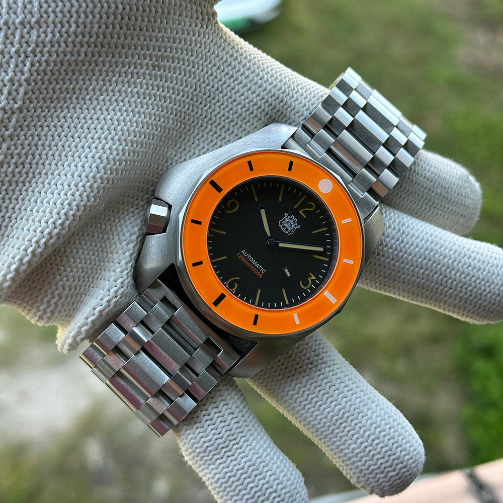 STEELDIVE SD2211 on its steel tank bracelet held in a gloved hand