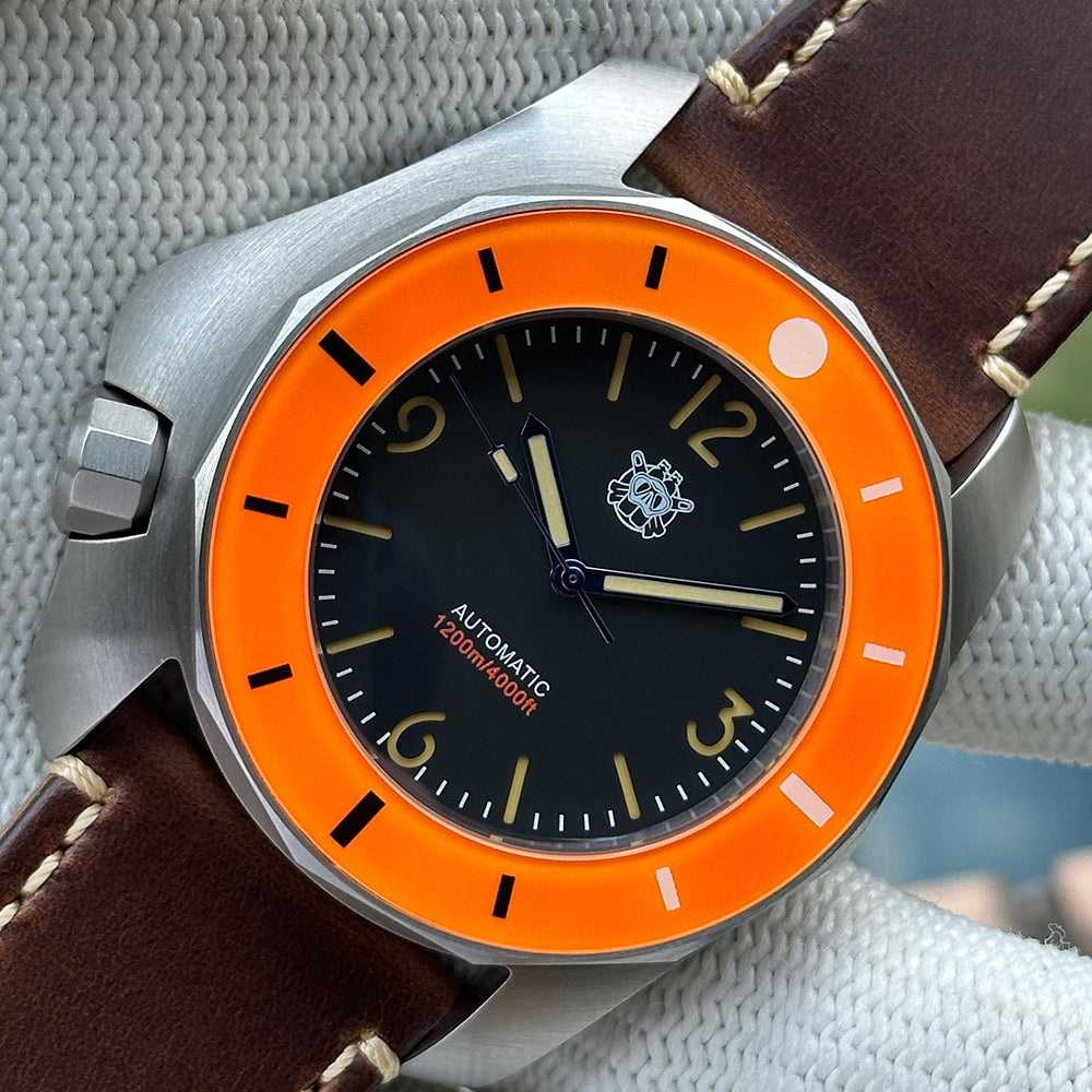 STEELDIVE SD2211 orange bezel dive watch with black dial on a dark brown leather strap
