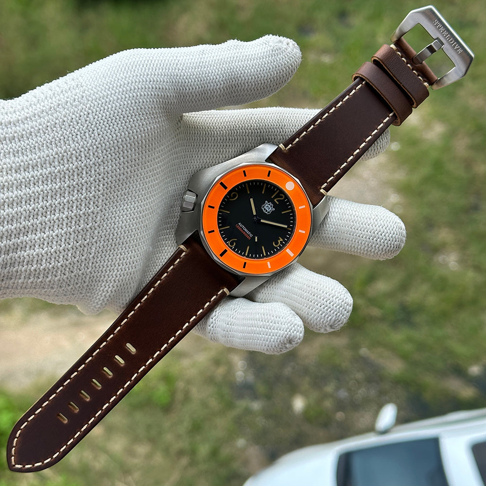 STEELDIVE SD2211 on a dark brown leather strap laid full length on a gloved hand