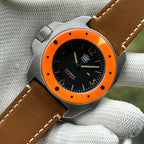 STEELDIVE SD2212 on a light brown leather strap laid full length on a gloved hand