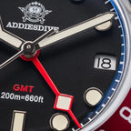 ADDIESDIVE AD2044 GMT close-up macro of black dial showing red GMT hand, sword hands and cream lume markers