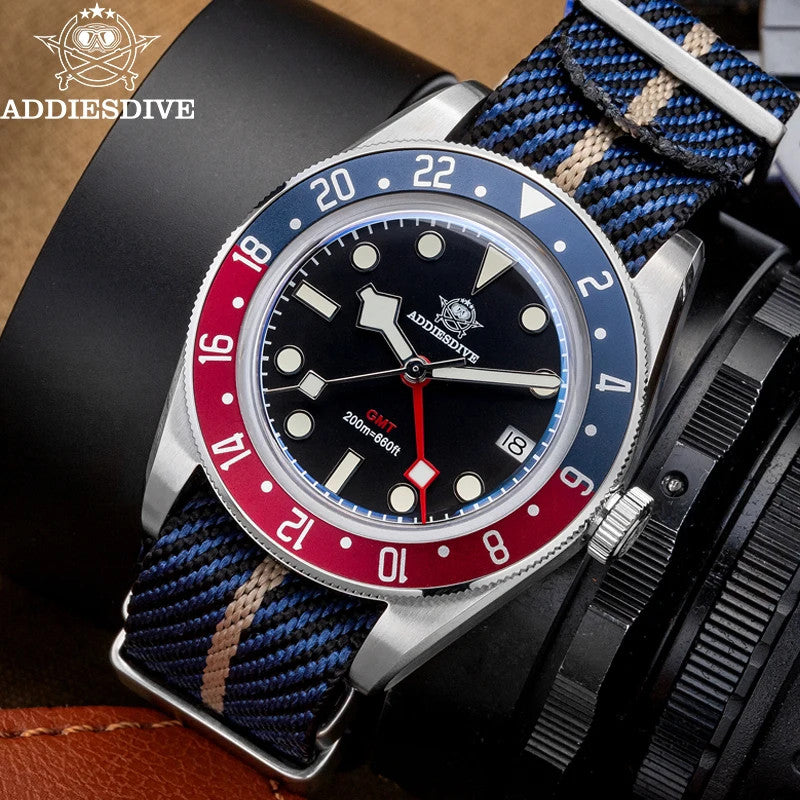 ADDIESDIVE AD2044 GMT with black dial, Pepsi bezel and blue-tan NATO strap, lifestyle shot on black leather
