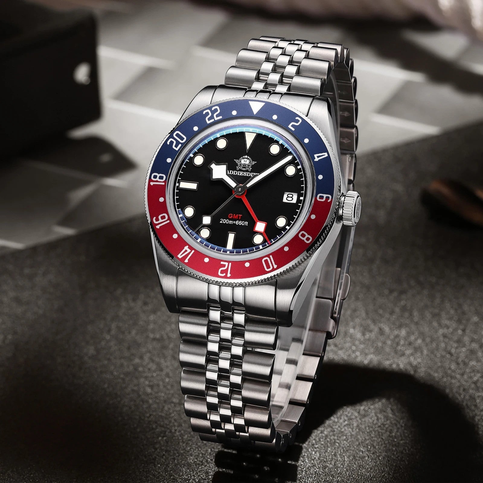ADDIESDIVE AD2044 GMT diver with black dial, red GMT hand, blue-red Pepsi bezel and jubilee steel bracelet, lifestyle shot
