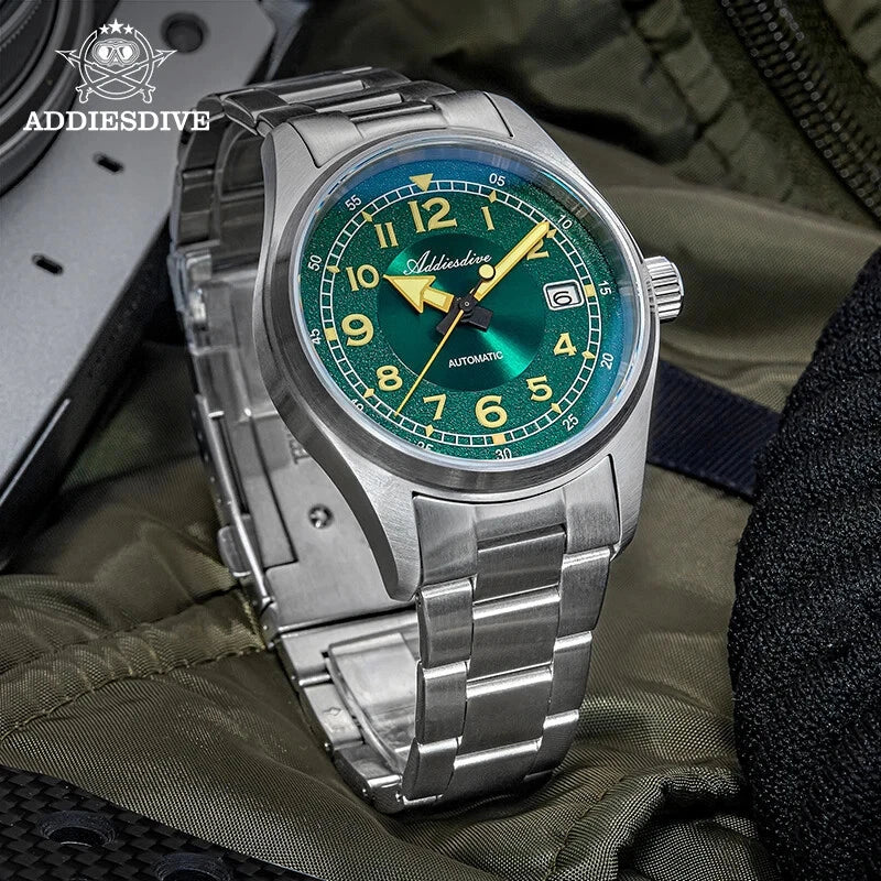 ADDIESDIVE AD2055 39MM NH35 automatic field watch with green sunburst dial and steel bracelet, lifestyle shot on tactical bag