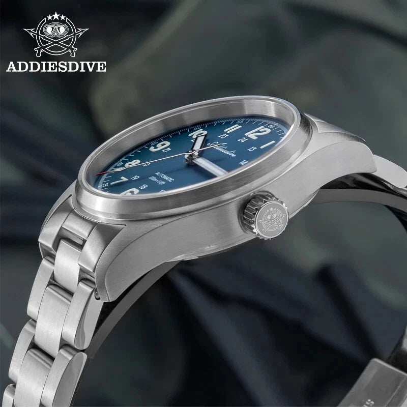 ADDIESDIVE AD2070 automatic field watch with blue dial showing bright cyan luminous Arabic numerals and hands in dark