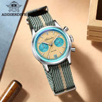 ADDIESDIVE AD2095 quartz chronograph with beige dial and green NATO strap, angled lifestyle shot on wood