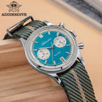 ADDIESDIVE AD2095 quartz chronograph with teal dial and green NATO strap, angled lifestyle shot on wood