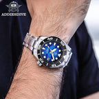 ADDIESDIVE AD2102 NH35 automatic dive watch with blue wave dial and steel bracelet, lifestyle shot with blue backdrop