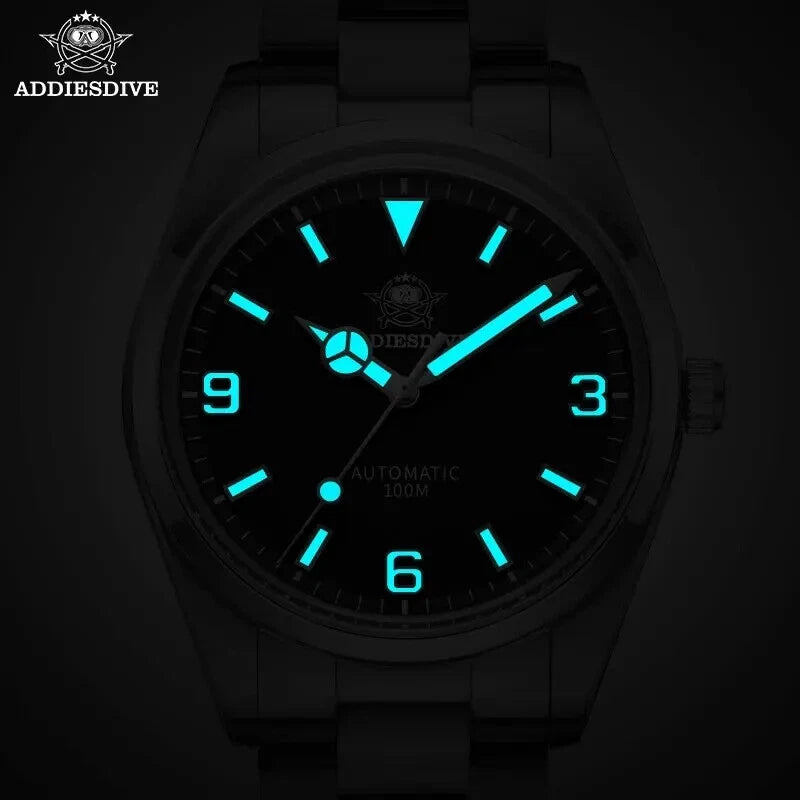 ADDIESDIVE AD2112 automatic Explorer-style showing bright cyan luminous hands, Arabic numerals and markers in dark