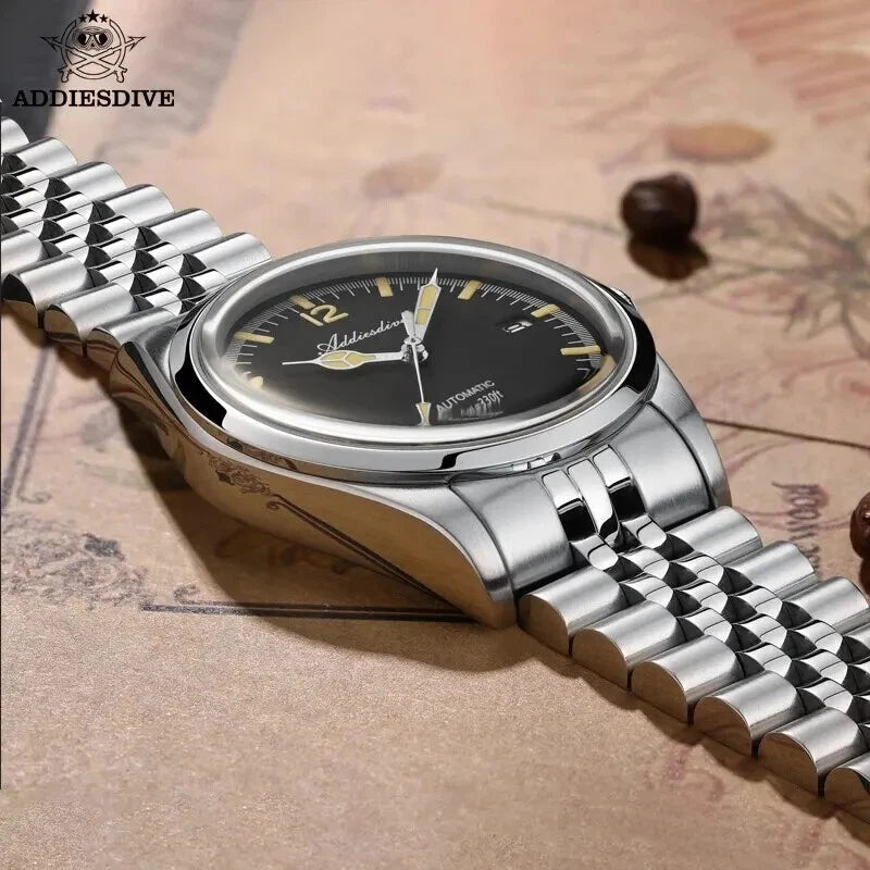 ADDIESDIVE AD2117 NH35 automatic vintage-style with black dial and jubilee bracelet, angled lifestyle shot on antique map
