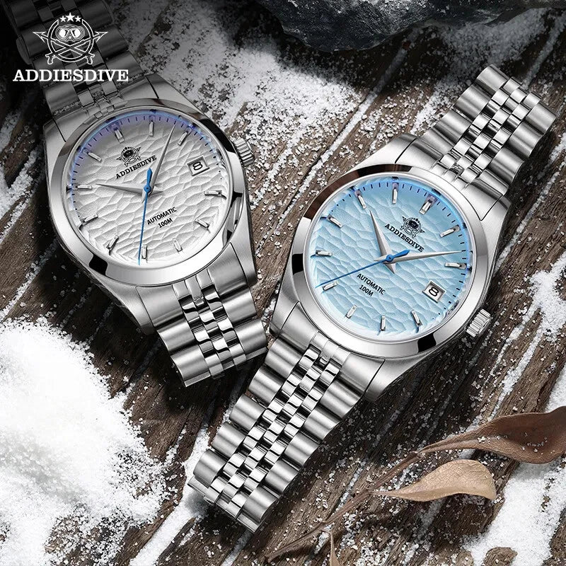ADDIESDIVE AD2118 automatic dress watch showing white and ice blue hammered dial variants with jubilee bracelets on snowy wood