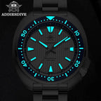 ADDIESDIVE AD2507 turtle-style diver quartz showing bright cyan luminous hands and markers in dark