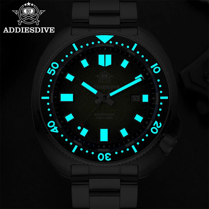 ADDIESDIVE AD2511 turtle-style diver quartz with green dial showing bright cyan luminous hands and markers in dark