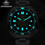 ADDIESDIVE AD2511 turtle-style diver quartz with green dial showing bright cyan luminous hands and markers in dark