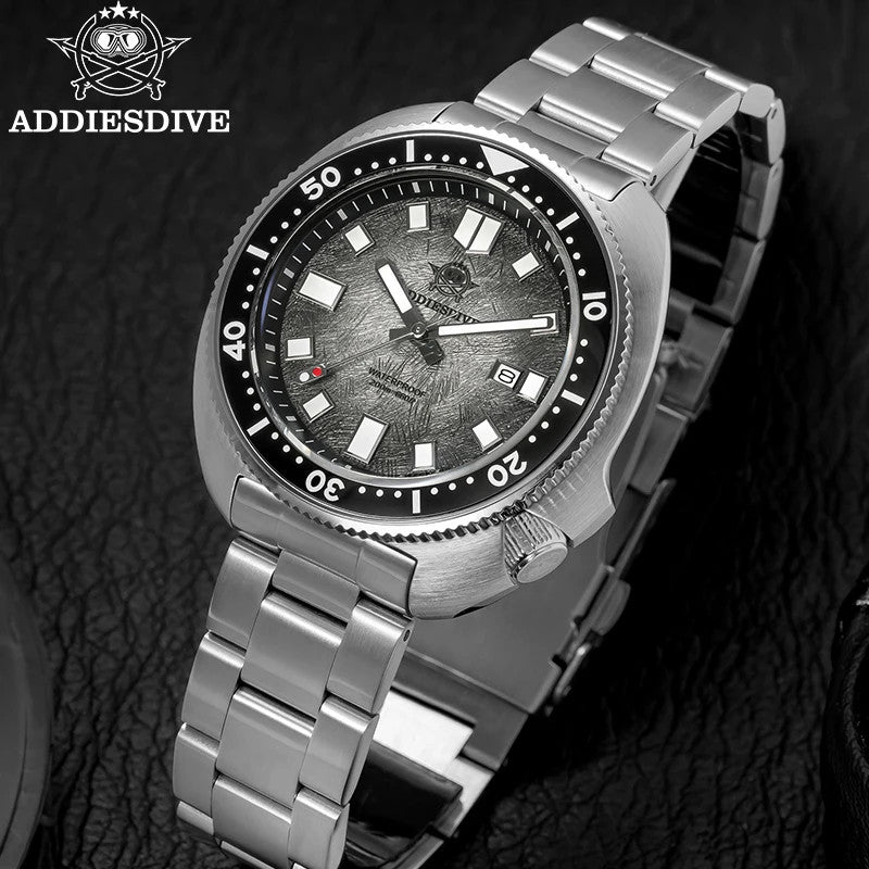 ADDIESDIVE AD2511 turtle-style diver quartz angled close-up of grey fluted dial with engraved crown and steel bracelet