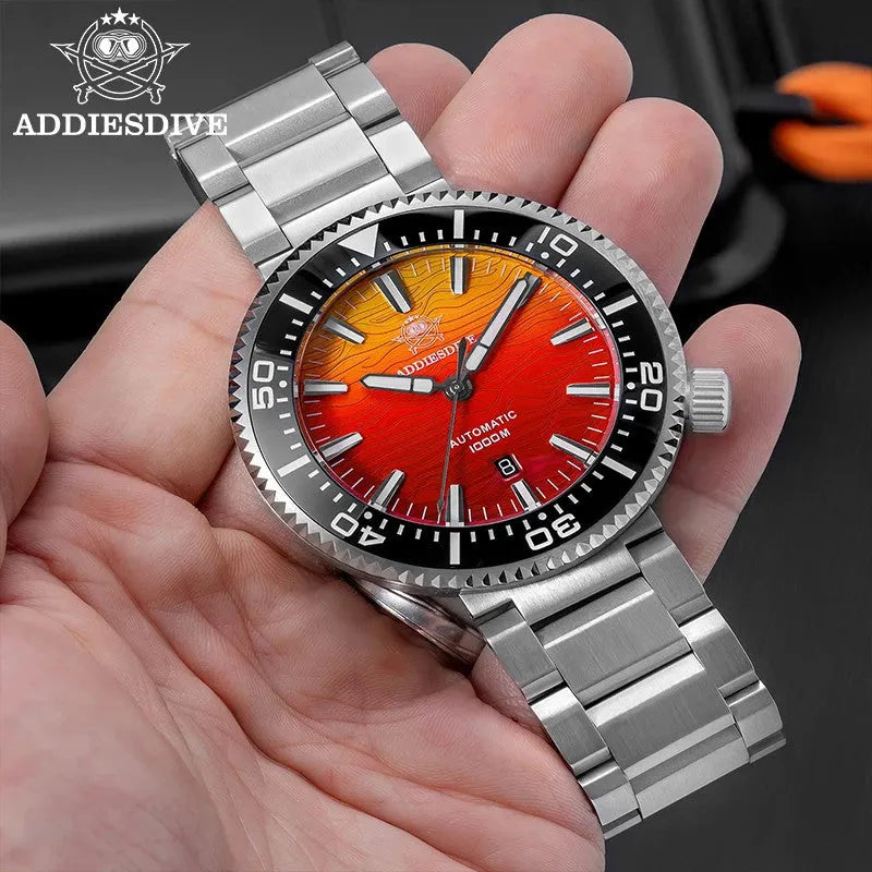 ADDIESDIVE AD2526 1000M automatic dive watch with red sunset dial and steel bracelet, held in hand