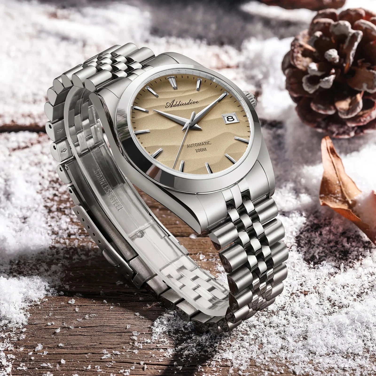 ADDIESDIVE 39MM automatic watch with sand dial and steel bracelet, lifestyle shot with snow and pinecone