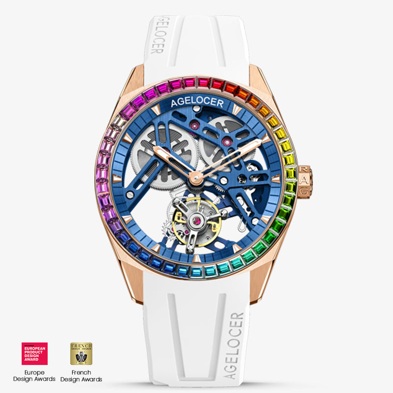 Agelocer rainbow tourbillon watch, rose gold case, blue skeleton dial, gem-set rainbow bezel, white strap