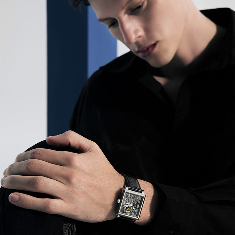 Agelocer Codex Double Skeleton square watch worn by a male model in a black shirt