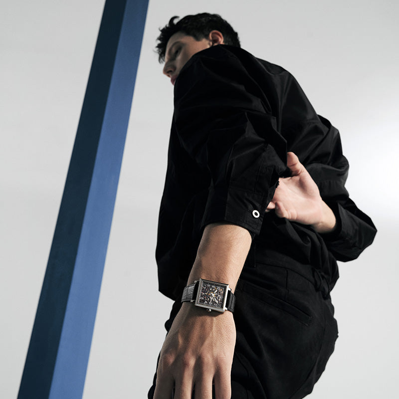 Male model wearing Agelocer Codex square skeleton automatic watch, studio lifestyle shot