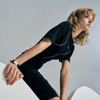 Female model wearing Agelocer Codex square quartz watch with white Roman dial, studio lifestyle shot